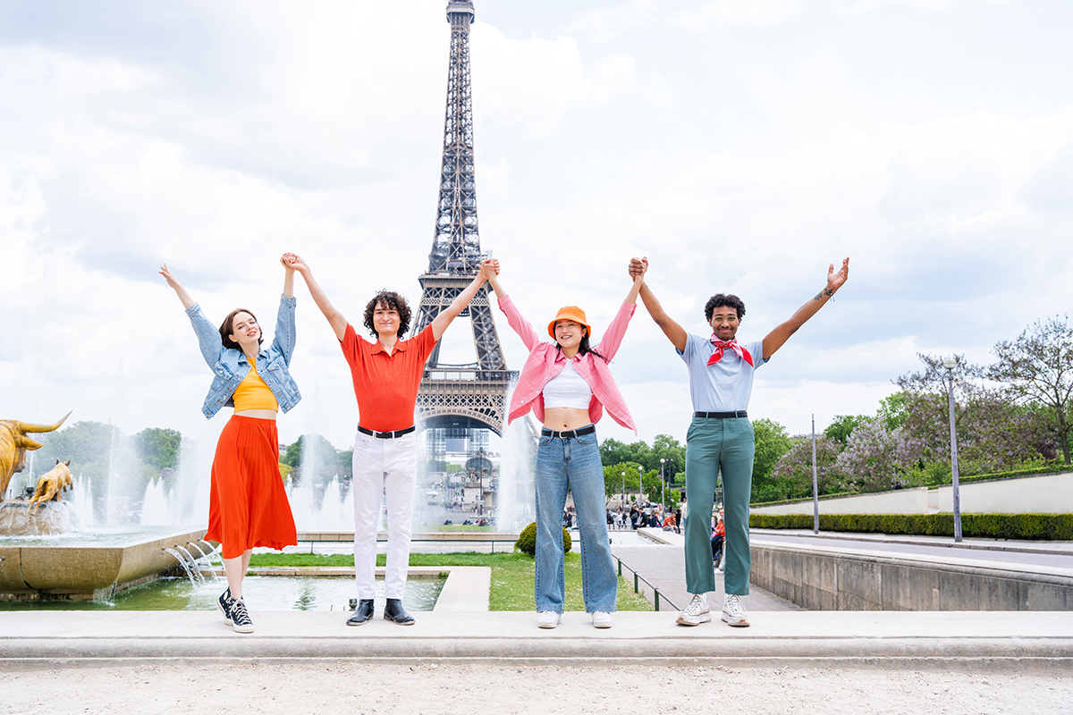 Group of young happy friends visiting Paris and Eiffel Tower, Trocadero area and Seine river - Multicultural group of tourists sightseeing the France capital city